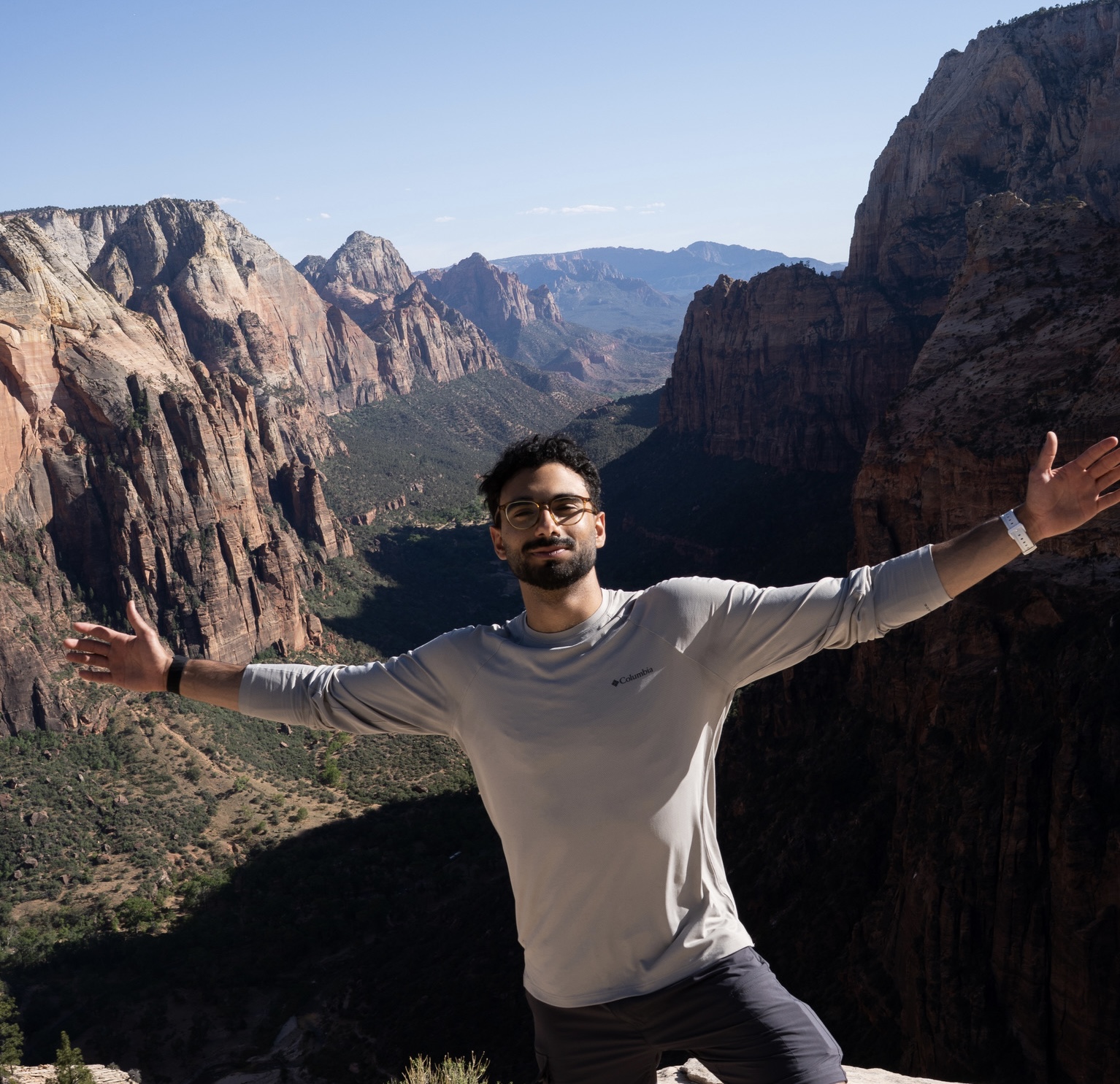 Mohamed Fouda with arms outstretched above a canyon in Zion National Park